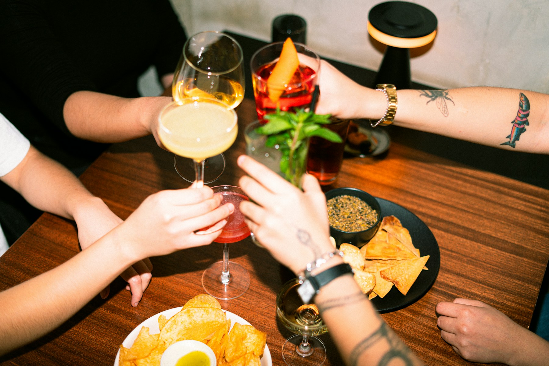 Guests sharing cocktails at the full bar