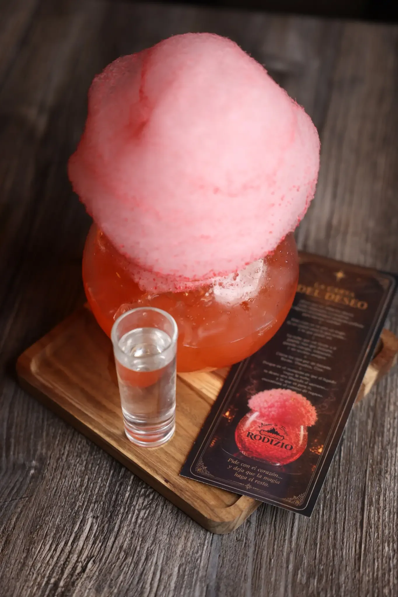 La Carta del Deseo signature cocktail topped with pink cotton candy